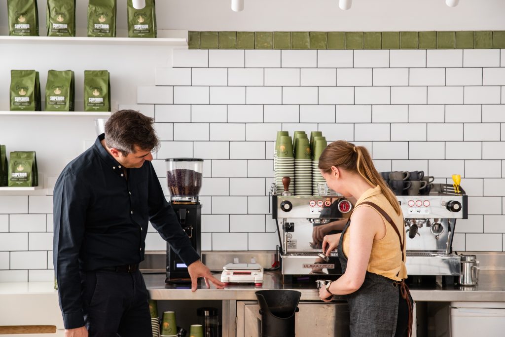 man and woman with coffee machine